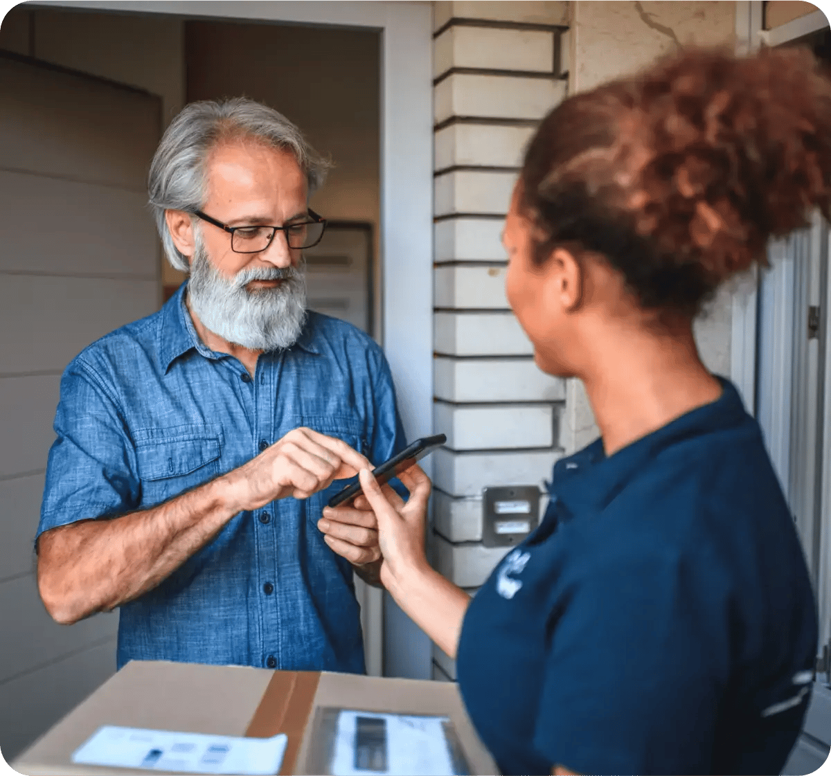 Woman delivering package to man using mobile phone