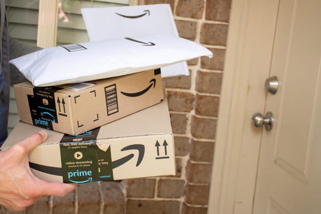 Amazon Prime boxes and envelopes delivered to the front door of residential building