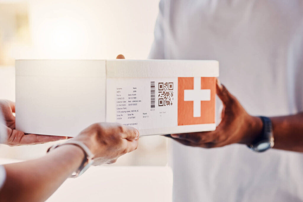 Close-up shot as a medical courier hands off a package of medical supplies to a client's customer.
