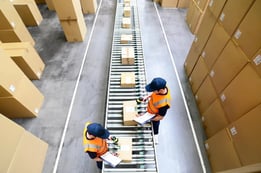 two men in warehouse with packages