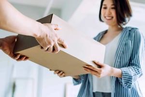 Happy woman receiving box package delivery