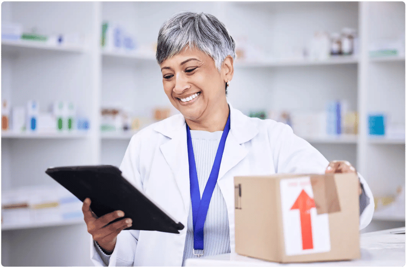 pharmacist looking at tablet smiling