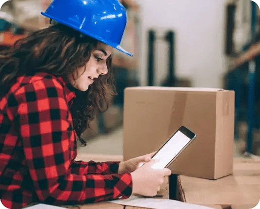 worker with helmet looking at phone
