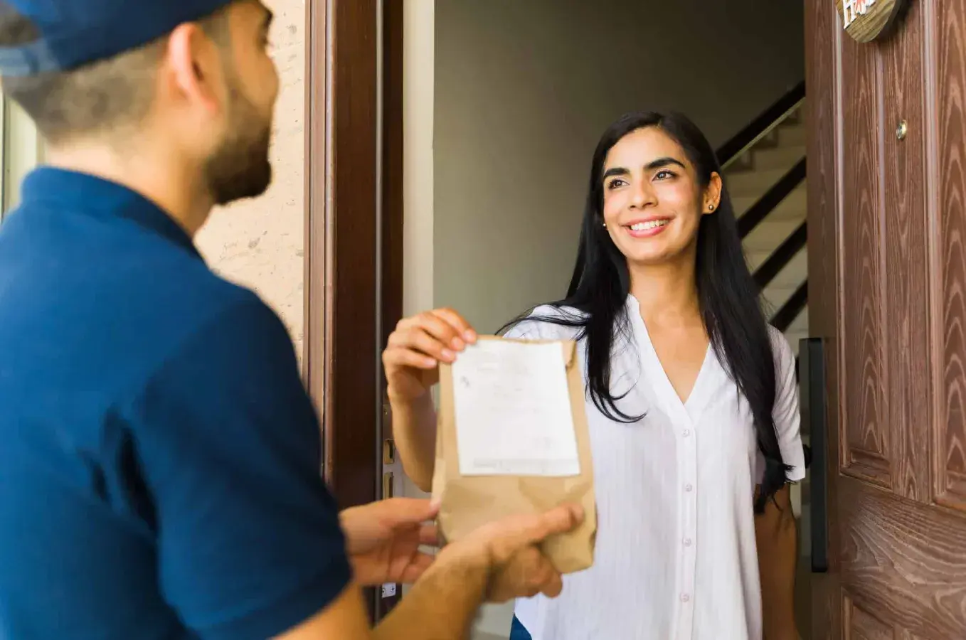 woman taking package at front door